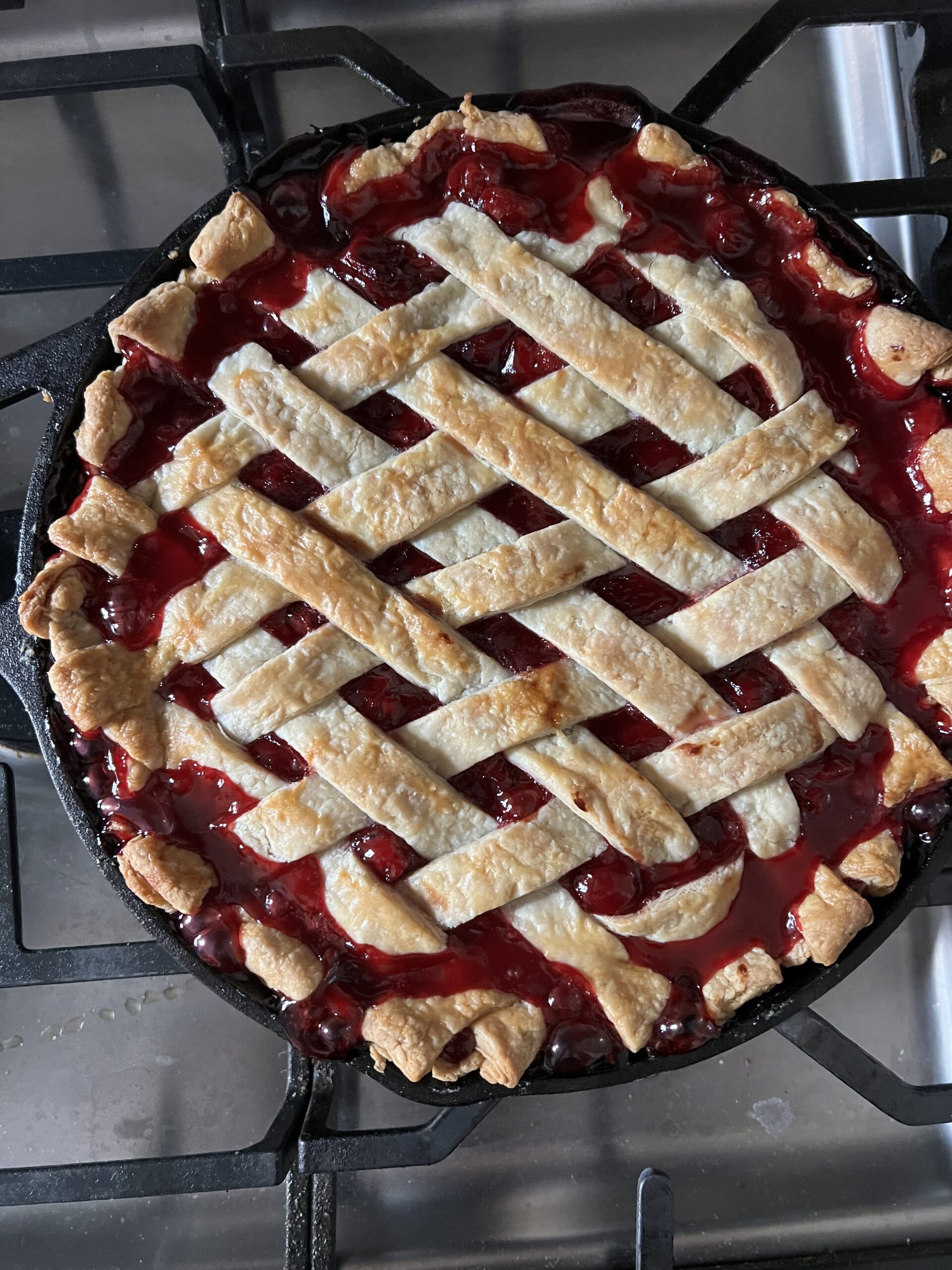 Cherry pie in a cast iron after baking on the grill